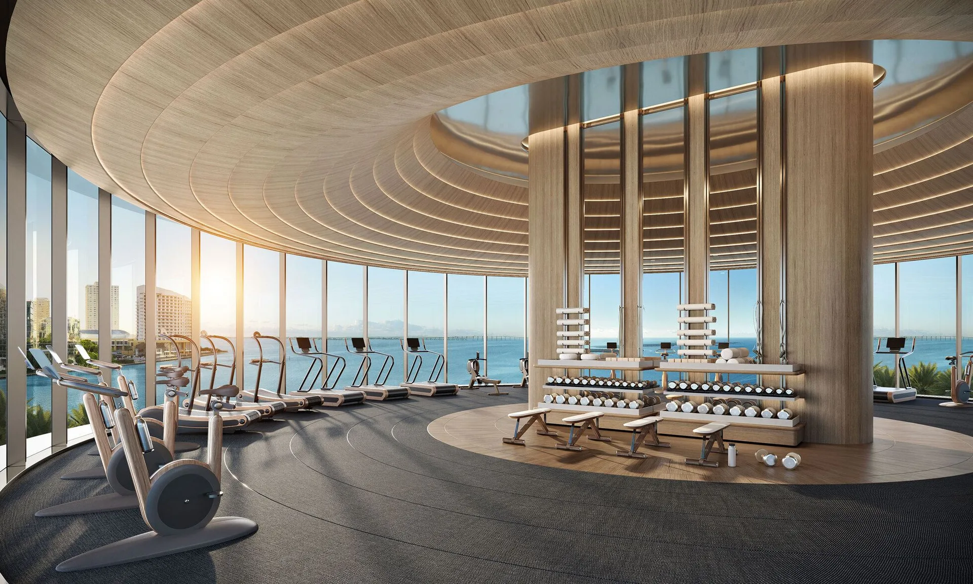 Gimnasio circular envuelto en vidrio con el mar en 360 grados